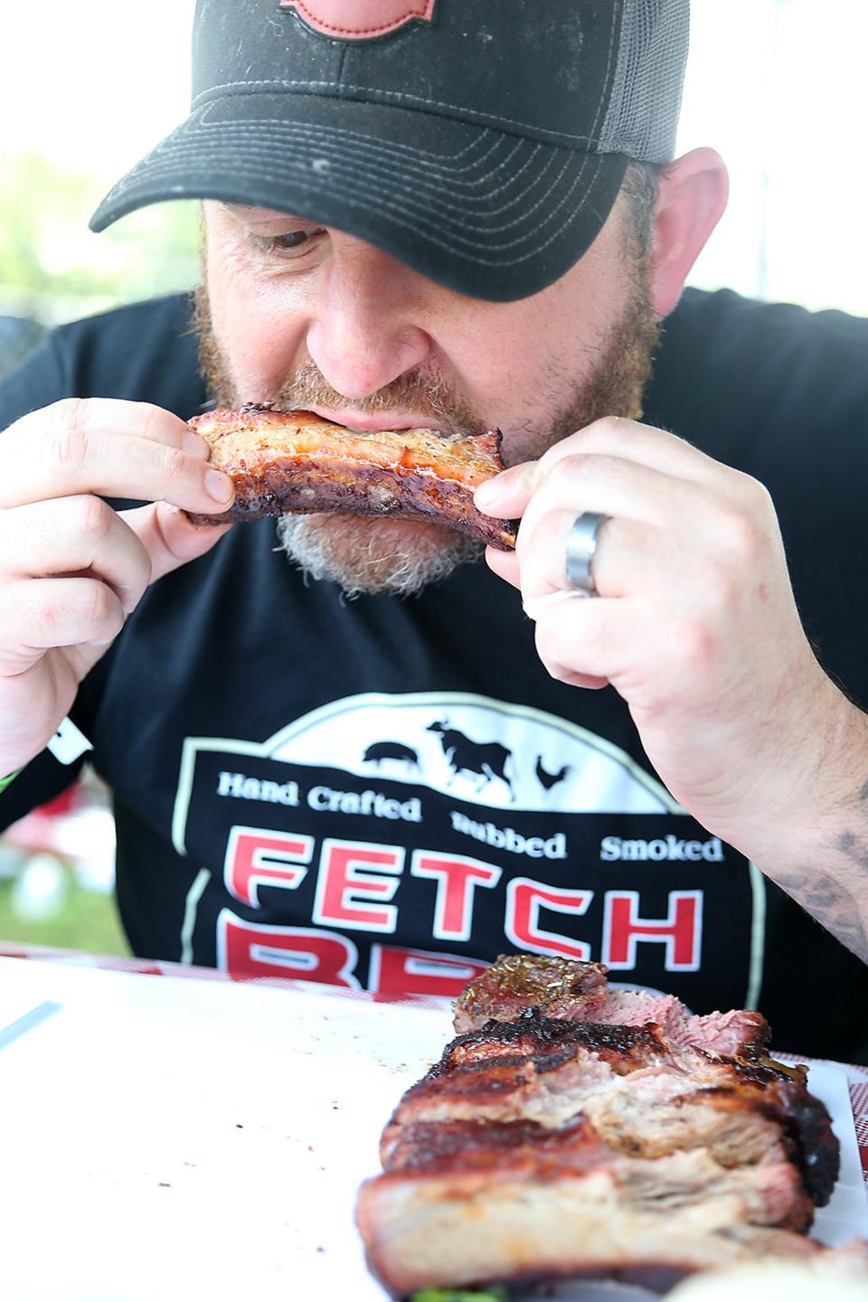 Dan Naples, of Fetch BBQ in Marshfield, takes a bite out of a rib while judging some of the 21 contestants in the Marshfield Community Rib Cook-Off at the Marshfield Fairgrounds on Saturday, Sept. 11, 2021.