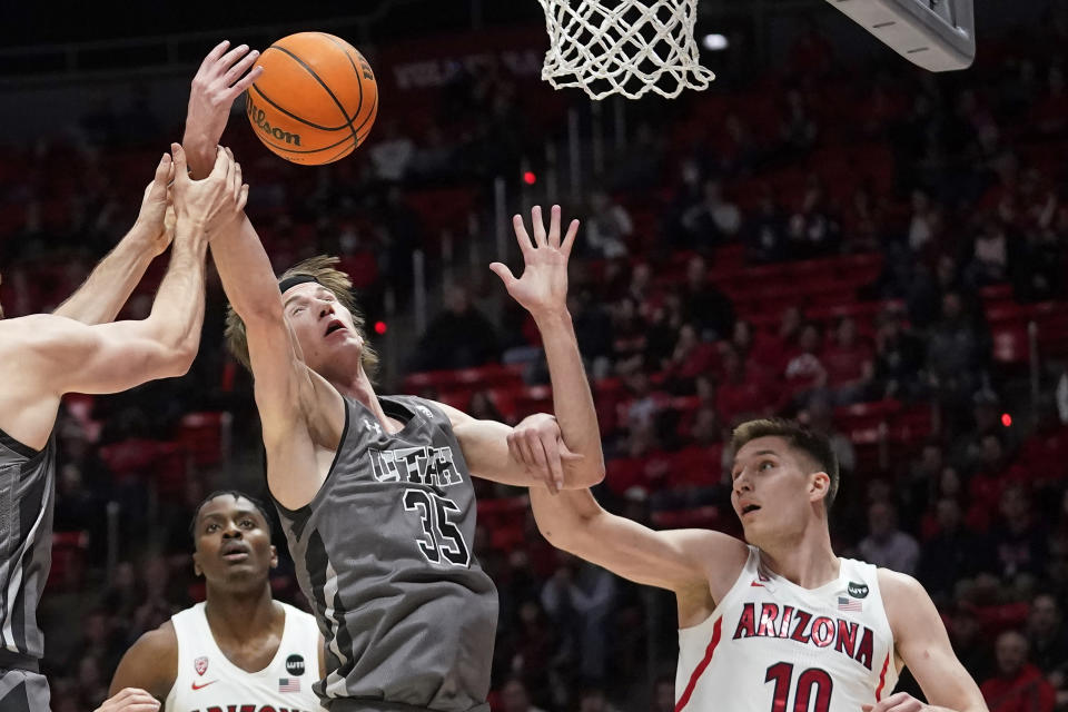 Utah center Branden Carlson (35) reaches for a rebound next to Arizona forward Azuolas Tubelis (10) during the first half during an NCAA college basketball game Thursday, Feb. 24, 2022, in Salt Lake City. (AP Photo/Rick Bowmer)