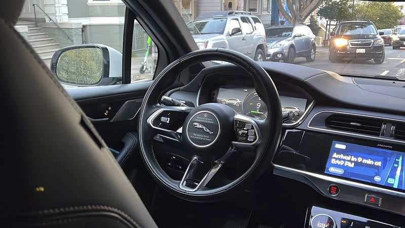 A Waymo driverless taxi drives on the street during a test ride in San Francisco, on Feb. 15, 2023. Self-driving cars are coming, but we should temper our excitement with a measure of realism. 