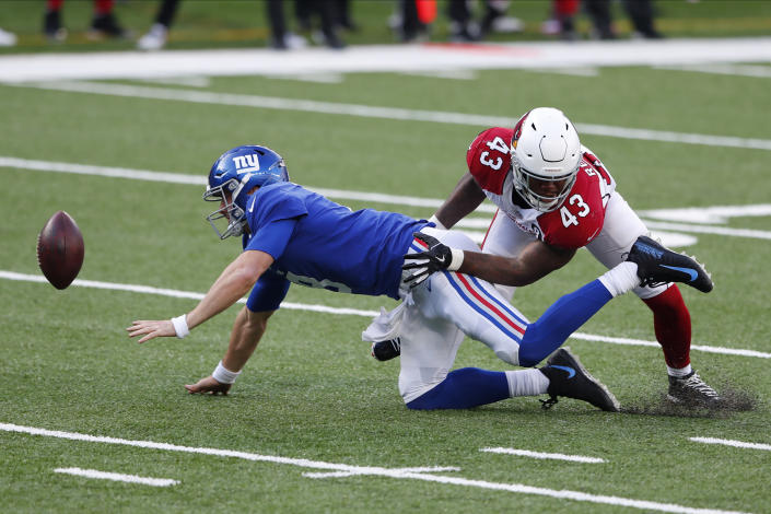 New York Giants quarterback Daniel Jones, left, tries to grab a loose ball while being tackled by Arizona Cardinals' Haason Reddick during the first half of an NFL football game, Sunday, Dec. 13, 2020, in East Rutherford, N.J. (AP Photo/Noah K. Murray)