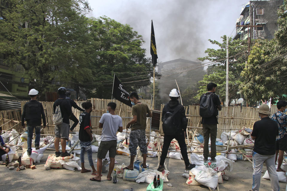 Anti-coup protesters stand behind a barricade during a demonstration in Dala township, Yangon, Myanmar, Saturday, March 27, 2021. As Myanmar’s military celebrated the annual Armed Forces Day holiday with a parade Saturday in the country’s capital, soldiers and police elsewhere reportedly killed dozens of people as they suppressed protests in the deadliest bloodletting since last month’s coup. (AP Photo)