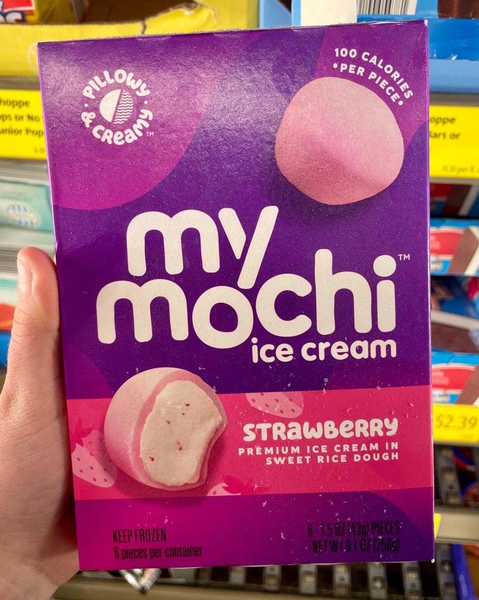 hand holding a purple box of my/mochi mochi ice cream at aldi