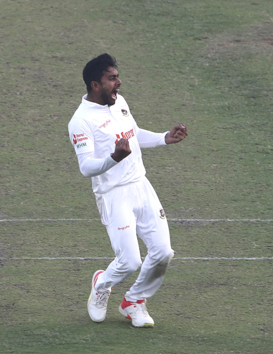 Bangladesh's Mehidy Hasan Miraz right celebrates wicket of India's Virat Kohli during the third day of the second cricket test match between Bangladesh and India, in Dhaka, Bangladesh, Saturday, Dec. 24, 2022. (AP Photo/Surjeet Yadav)