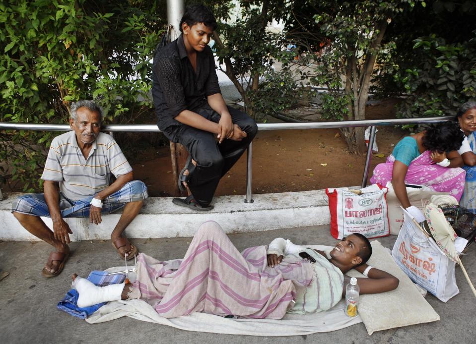 Indian patients are evacuated from a government hospital following a tremor in Chennai, India, Wednesday, April 11, 2012. Two massive earthquakes off Indonesia’s western coast triggered back-to-back tsunami warnings for most areas of the Indian Ocean on Wednesday, sending panicked residents fleeing to high ground in cars and on the backs of motorcycles. There were no signs of deadly waves, however, or serious damage, and a watch for much of the Indian Ocean was lifted after a few hours. (AP Photo/Arun Shanker)