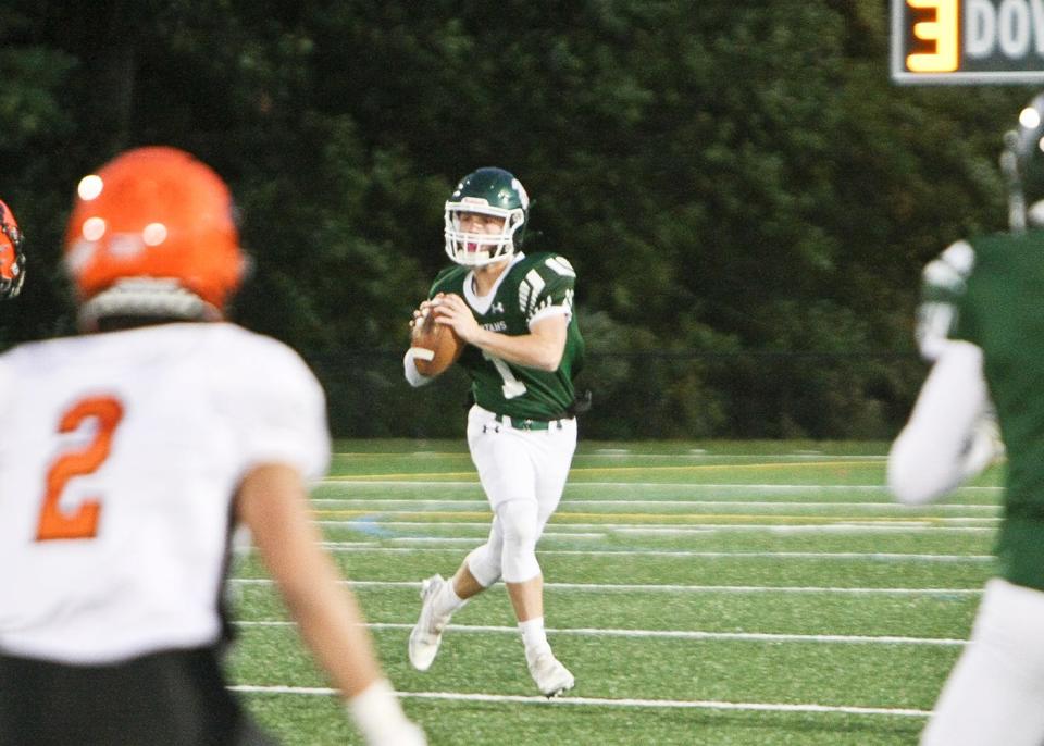 Oakmont quarterback Sam Curtis keeps his eyes downfield looking for an open receiver.