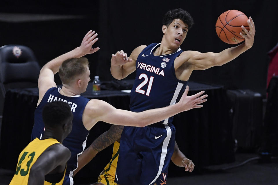 Virginia's Kadin Shedrick (21) pulls in a round in the first half of an NCAA college basketball game against San Francisco, Friday, Nov. 27, 2020, in Uncasville, Conn. (AP Photo/Jessica Hill)