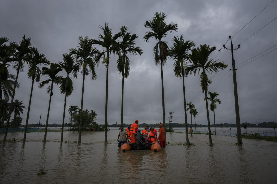 National Disaster Response Force (NDRF) personnel rescue flood-affected villagers in Korora village, west of Gauhati, India, Friday, June 17, 2022. (AP Photo/Anupam Nath)