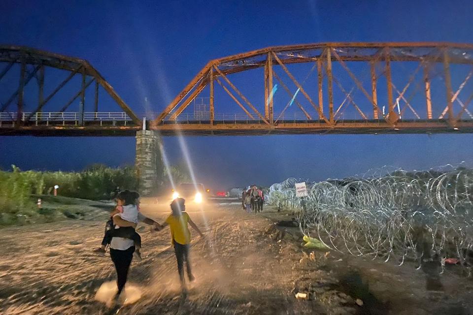 September 22, 2023: Migrants walk after wading the Rio Grande at the US-Mexico border in Eagle Pass, Texas.