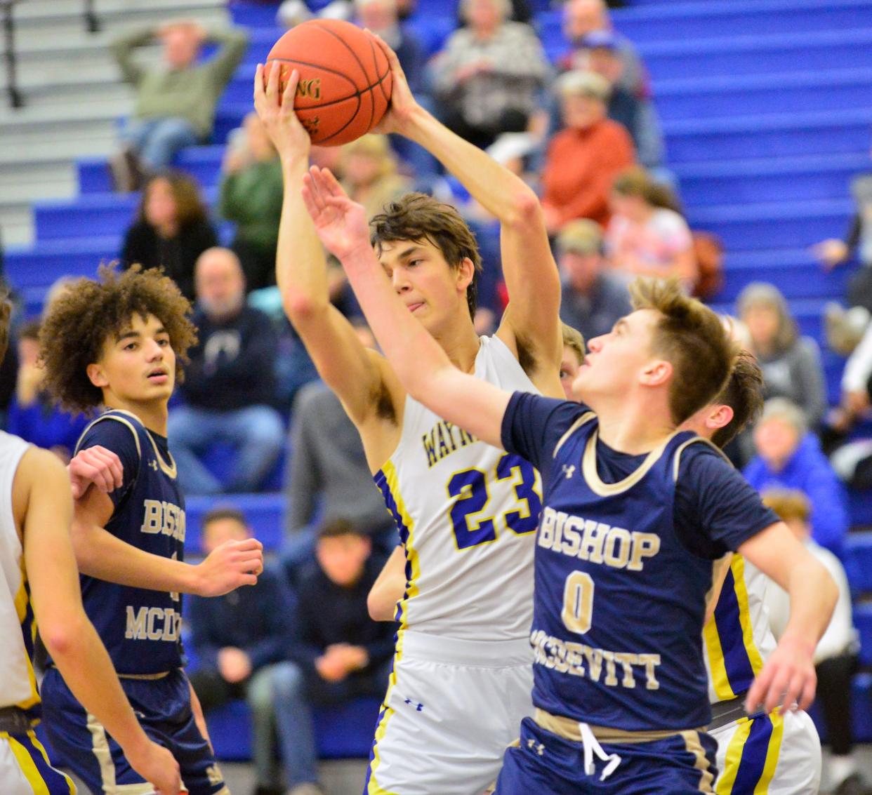 Alex Torbica controls a rebound over Bishop McDevitt's Ethan Hammer. Bishop McDevitt defeated Waynesboro, 34-31, during the Franklin County Vs. Tournament, Friday December 8, 2023 in Waynesboro.