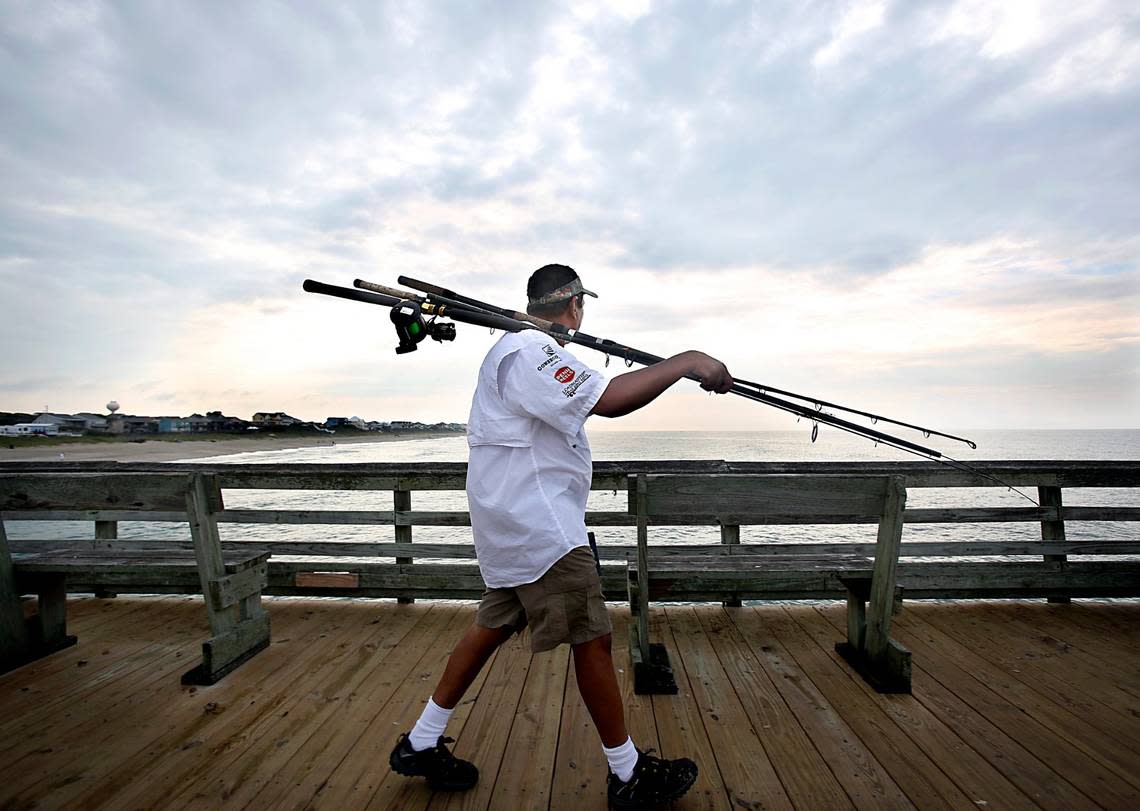 King Mackerel fisherman Sunny Patel, of Emerald Isle, heads to the far end of the Bogue Inlet Fishing Pier in Emerald Isle, N.C. in July 2015.