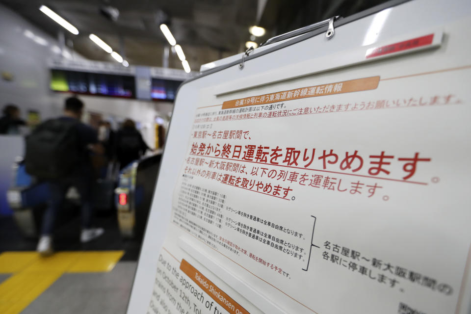 A notice paper on suspending operations of the Shinkansen or bullet train on Oct. 12-13 due to Typhoon Hagibis, is posted at Tokyo Station in Tokyo Friday, Oct. 11, 2019. Japan's weather agency is warning a powerful typhoon may bring torrential rains to central Japan over the weekend. (AP Photo/Eugene Hoshiko)