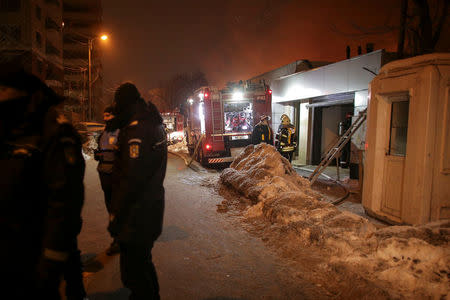 Romanian gendarmes cordon off a part of a street as firefighters work at the scene of a fire that destroyed a night club in Bucharest, Romania, January 21, 2017. Inquam Photos/Octav Ganea/via REUTERS