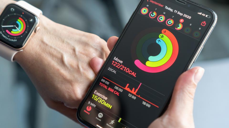 A photo of a running watch and phone showing calories burned