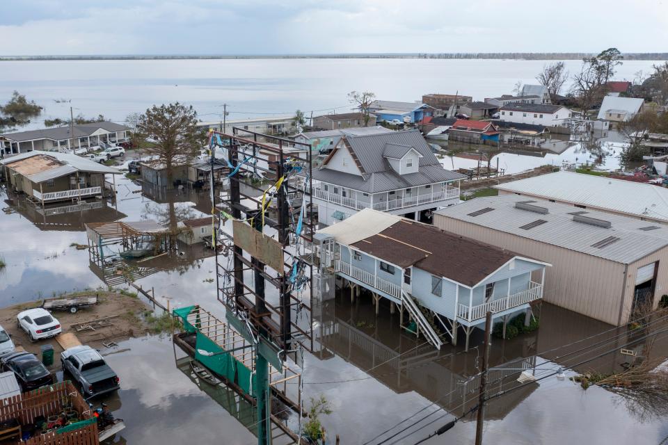 Flood waters surround storm damaged homes on Aug. 31, 2021, in Lafourche Parish, La., as residents try to recover from the effects of Hurricane Ida.