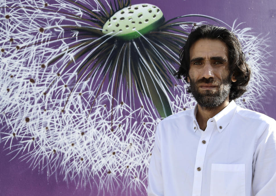 In this Nov. 19, 2019, photo, Behrouz Boochani, the Kurdish film-maker, writer and refugee who has documented life inside the Australian offshore immigration camp on Manus Island, poses for a portrait in Christchurch, New Zealand. (AP Photo/Mark Baker)