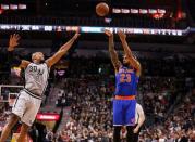 Jan 8, 2016; San Antonio, TX, USA; New York Knicks power forward Derrick Williams (23) shoots the ball over San Antonio Spurs power forward David West (30) during the second half at AT&T Center. Mandatory Credit: Soobum Im-USA TODAY Sports