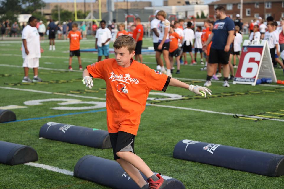 Kids take part in the Play Football Skills Camp at the The Hall of Fame Village's ForeverLawn Sports Complex, Tuesday, Aug. 1, 2023, in Canton.