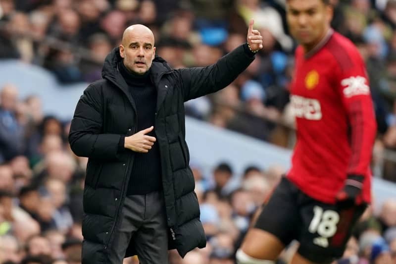 Manchester City manager Pep Guardiola (L) gestures on the touchline during the English Premier League soccer match between Manchester City and Manchester United at the Etihad Stadium. Mike Egerton/PA Wire/dpa