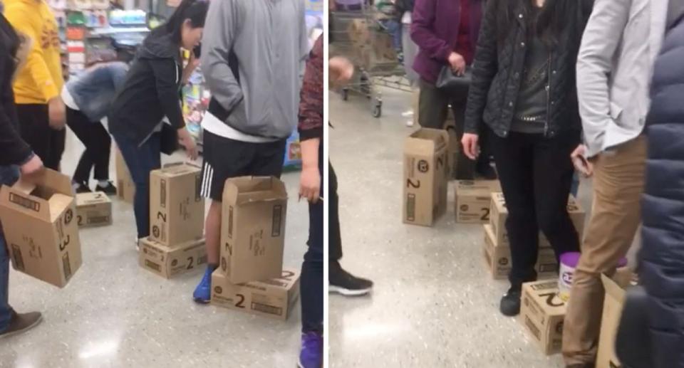 Customers stand with boxes of formula in Woolworths despite their two tin limit. Source: Reddit