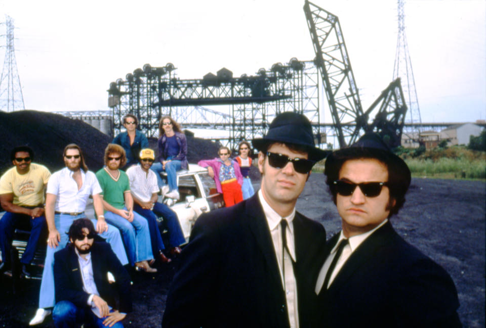 Canadian actor and screenwriter Dan Aykroyd and American actor John Belushi, with director John Landis (L) on the set of his movie The Blues Brothers. (Photo by Sunset Boulevard/Corbis via Getty Images)