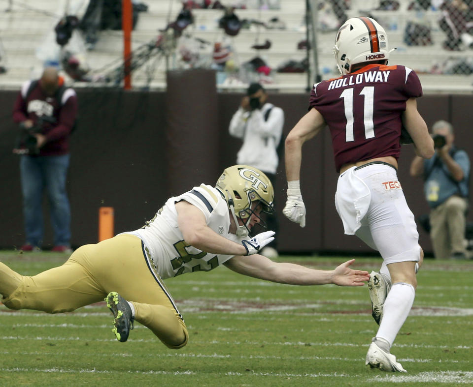 Virginia Tech's Tucker Holloway (11) runs past Georgia Tech punter David Shanahan (43) as he returns a punt for a touchdown in the first half during an NCAA college football game, Saturday, Nov. 5 2022, in Blacksburg, Va. (Matt Gentry/The Roanoke Times via AP)