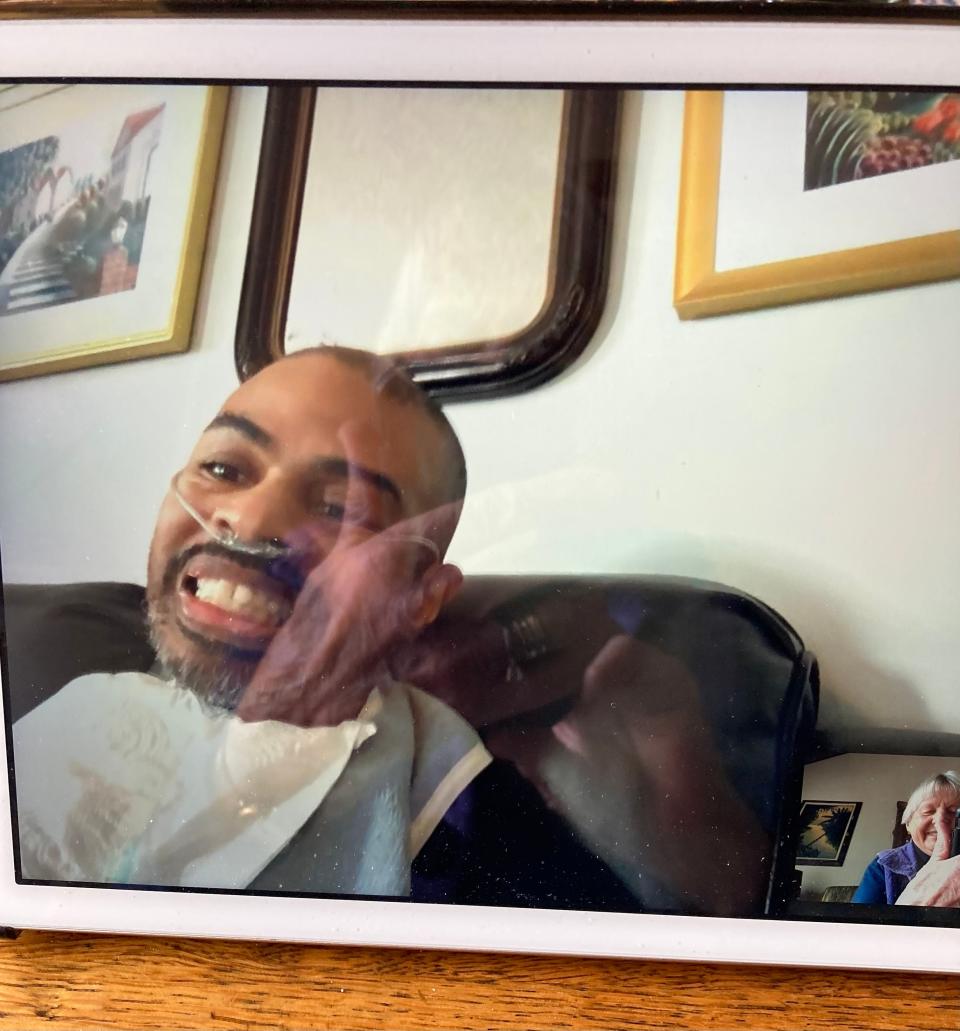 Eduardo Trotman of West Palm Beach, Florida, who has ALS, gives a big smile while conversing with Carole Gariepy of Phillipston.