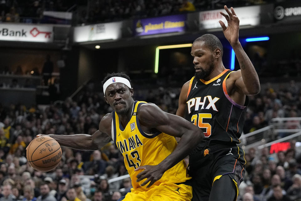 Indiana Pacers' Pascal Siakam (43) is defended by Phoenix Suns' Kevin Durant (35) during the second half of an NBA basketball game Friday, Jan. 26, 2024, in Indianapolis. (AP Photo/Darron Cummings)