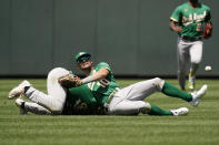 Oakland Athletics second baseman Jonah Bride, left, and right fielder Chad Pinder (10) collide while trying to field an RBI single hit by Kansas City Royals' Edward Olivares during the sixth inning of a baseball game Sunday, June 26, 2022, in Kansas City, Mo. (AP Photo/Charlie Riedel)