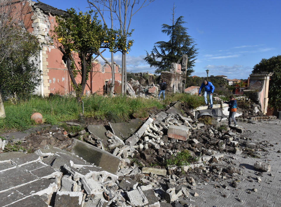 Debris stand in front of a damaged building in Fleri, near the Sicilian city of Catania, Italy, Wednesday, Dec. 26, 2018. A quake triggered by Mount Etna’s ongoing eruption jolted eastern Sicily before dawn Wednesday, injuring 10 people, damaging churches and houses in hamlets on the volcano’s slopes and prompting panicked villagers to flee their homes. (Orietta Scardino/ANSA Via AP)