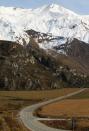 A car drives along Mt. Aspiring road in Wanaka, New Zealand.