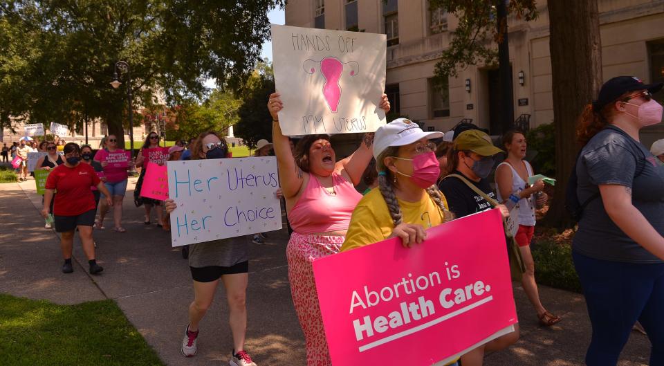 A group participates in a rally in front of the State House in Columbia, Tuesday morning, July 19, 2022. The rally was organized by the Women's Rights and Empowerment Network (WREN) in response to the House ad hoc committee's second hearing on abortion legislation.
