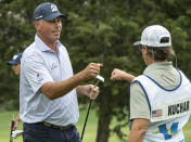 Matt Kucher, gets a fist bumps from his caddie, Brian Reed, after a birdie on the eleventh hole during the first round of the Valero Texas Open golf tournament, Thursday, March 30, 2023, in San Antonio. (AP Photo/Rodolfo Gonzalez )