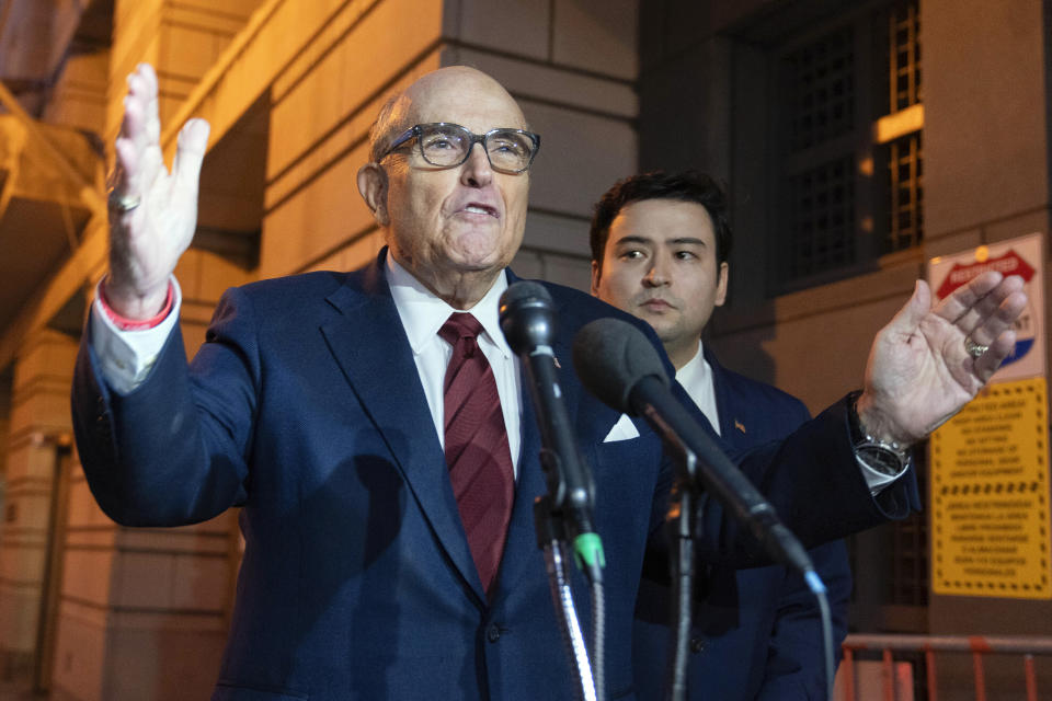 Former New York Mayor Rudy Giuliani talks to reporters as he leaves the federal courthouse in Washington, Monday, Dec. 11, 2023. The trial will determine how much Giuliani will have to pay two Georgia election workers who he falsely accused of fraud while pushing President Donald Trump's baseless claims after he lost the 2020 election. (AP Photo/Jose Luis Magana)