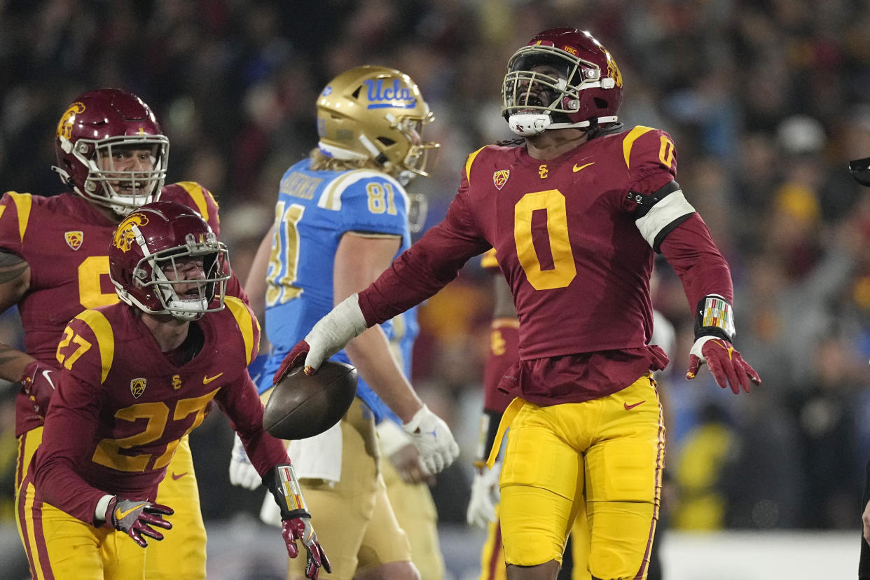 USC's Korey Foreman celebrates after intercepting a pass during the second half of the Trojans' win over UCLA on Saturday. (AP)