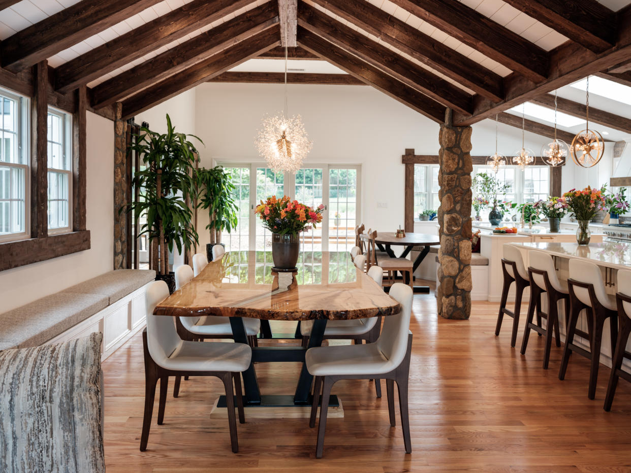  Open plan kitchen diner with chairs round the table. 