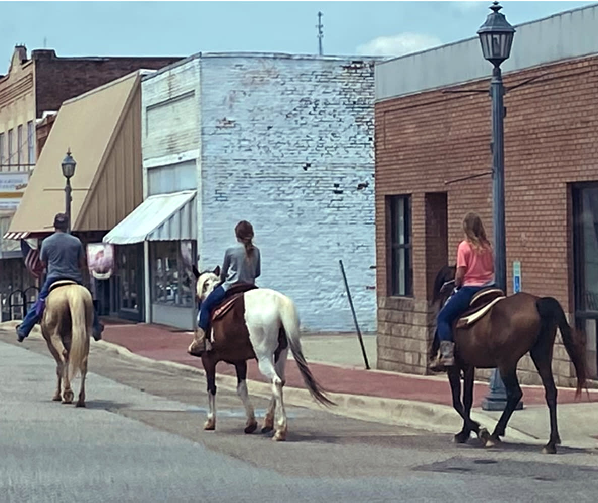 Image: Barry Walker, left, rides horses through Glenwood, Ark. with young girls. (Courtesy Howard Green)
