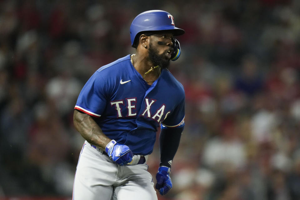 Texas Rangers' Adolis Garcia watches the flight of his home run during the third inning of a baseball game against the Los Angeles Angels ,Wednesday, Sept. 27, 2023, in Anaheim, Calif. (AP Photo/Jae C. Hong)