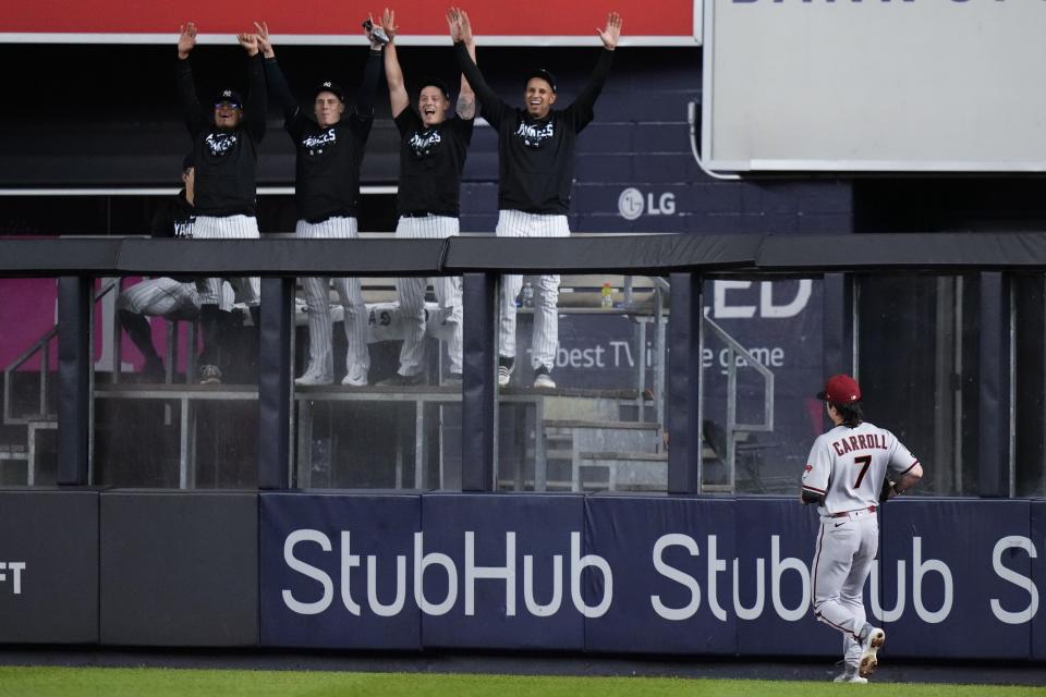 Arizona Diamondbacks right fielder Corbin Carroll chases the ball hit by New York Yankees' Aaron Judge for a two-run home run as Yankees players celebrate during the fifth inning of a baseball game Friday, Sept. 22, 2023, in New York. (AP Photo/Frank Franklin II)