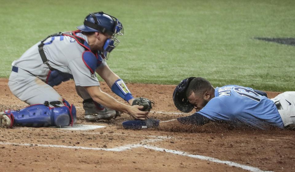 Tampa Bay Rays baserunner Manuel Margot is tagged out at the plate by Dodgers catcher Austin Barnes.