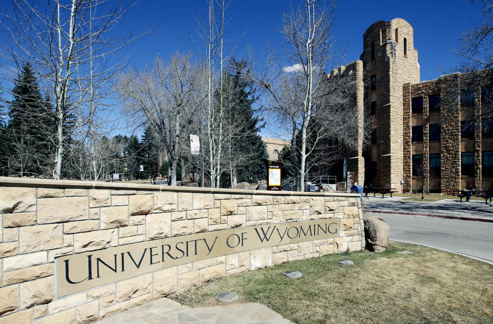 FILE - The University of Wyoming campus sign with the Wyoming Union in the background Friday March 23, 2012 in Laramie, Wyo. A single-vehicle wreck on a highway in northern Colorado killed three members of the University of Wyoming swimming and diving team. The crash happened Thursday, Feb. 23, 2024 on U.S. 287 about 10 miles (16 kilometers) south of the Wyoming-Colorado line between Laramie and Fort Collins, Colo. (Andy Carpenean/Laramie Boomerang via AP)