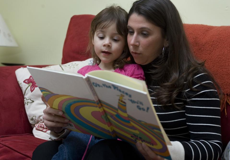 Tara Beams reads to her daughter in this file photo.