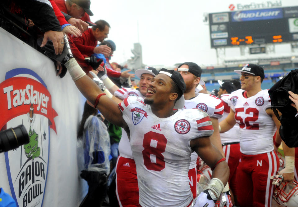 Nebraska running back Ameer Abdullah (8) celebrates with fans after their 24-19 win in the Gator Bowl NCAA college football game against Georgia, Wednesday, Jan. 1, 2014, in Jacksonville, Fla. (AP Photo/Stephen B. Morton)