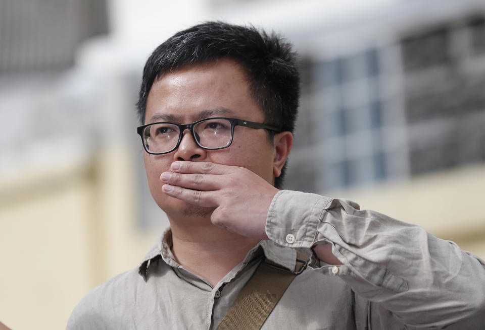 Pro-democracy activist Arnon Nampha raises a three-fingers salute, a symbol of resistance at Chana SongKhram police station in Bangkok, Thailand Monday, Nov. 30, 2020. The leaders of the pro-democracy protests reported themselves to the police for the additional charge of violating the lese majeste laws at Chanasongkram Police Station on Monday afternoon. (AP Photo/Sakchai Lalit)