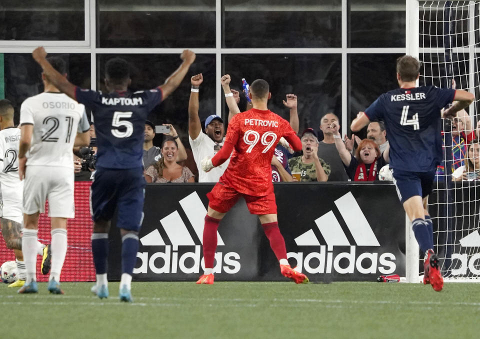 New England Revolution goalkeeper Djordje Petrovic (99) celebrates with fans after blocking a penalty kick by Toronto FC's LKorenzo Insigne during the second half of an MLS soccer match Saturday, July 30, 2022, in Foxborough, Mass. (AP Photo/Mary Schwalm)