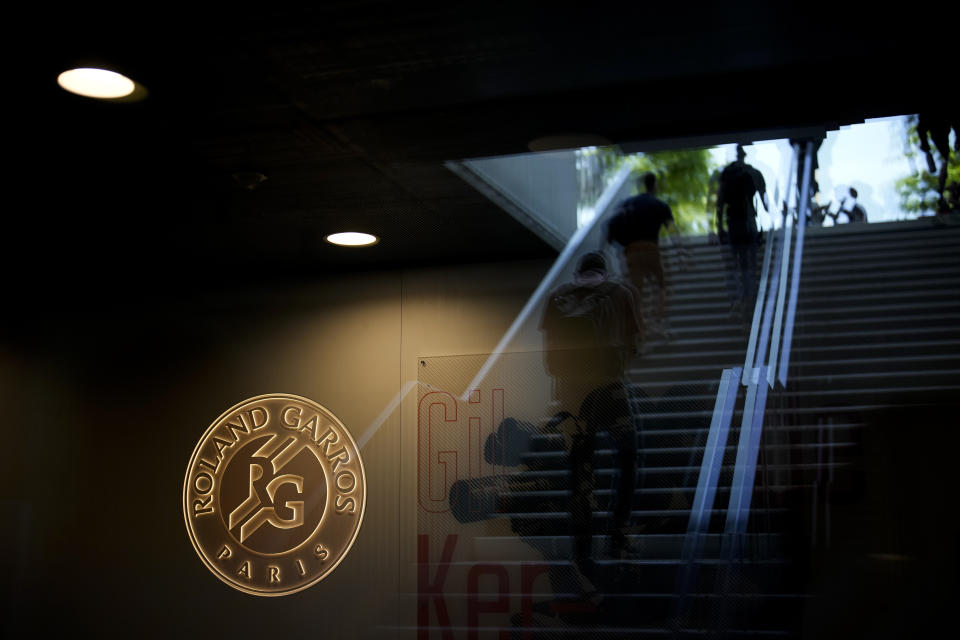 Spectators walks up the stadium stairs to watch first round matches of the French Open tennis tournament at the Roland Garros stadium in Paris, Tuesday, May 30, 2023. (AP Photo/Christophe Ena)