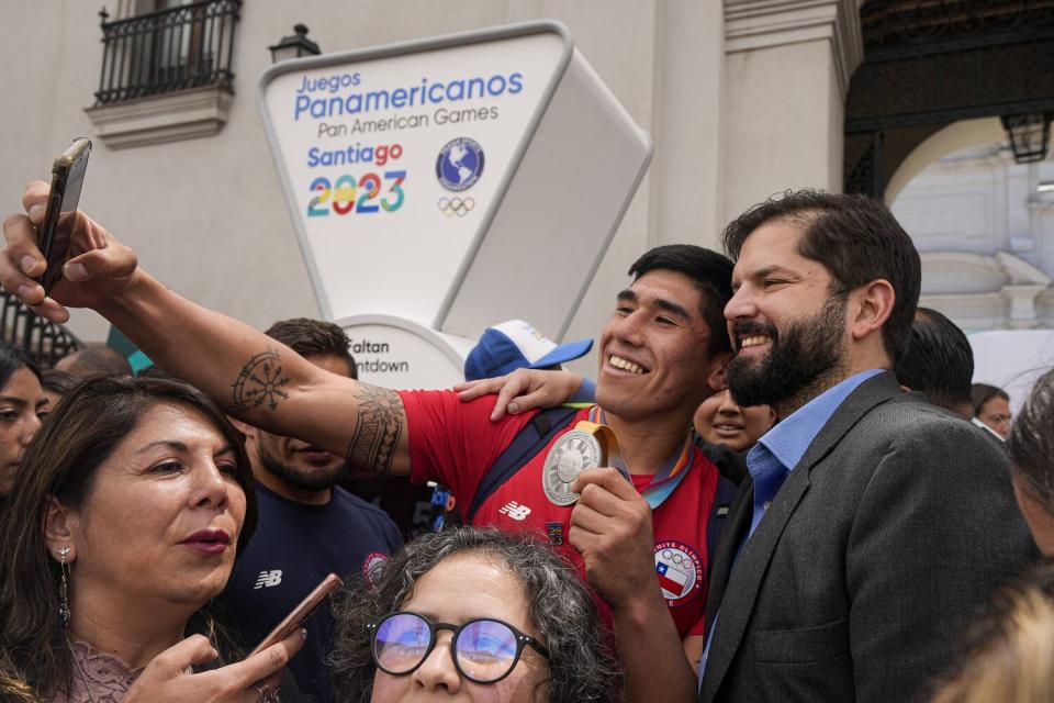 Chilean President Gabriel Boric, right, with a supporter.