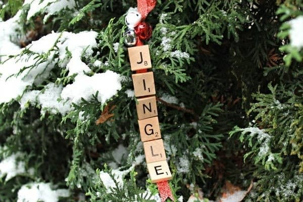 Scrabble tiles spelling "Jingle" hanging from a tree