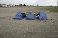 Tents are set up in a makeshift camp outside Calais, northern France, Saturday, Nov. 27, 2021. At the makeshift camps outside Calais, migrants are digging in, waiting for the chance to make a dash across the English Channel despite the news that at least 27 people died this week when their boat sank a few miles from the French coast. (AP Photo/Rafael Yaghobzadeh)