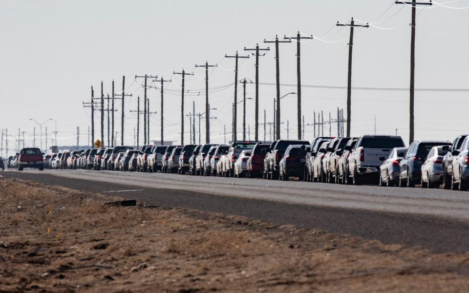 Motorists wait in line for the second dose of the Pfizer vaccine on Texas Loop 338  - Odessa American