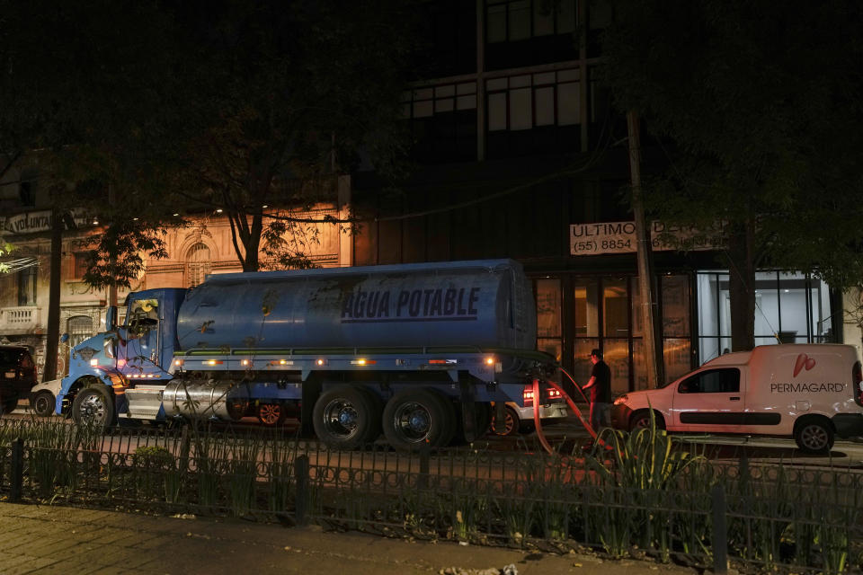A water truck delivers water in the Roma neighborhood of Mexico City, Thursday, March 7, 2024. Around this country of nearly 130 million, drought is draining reservoirs dry and creating severe water shortages. (AP Photo/Eduardo Verdugo)